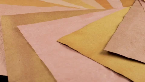 Handmade paper sheets in warm earth tones of beige, ochre, and pale terracotta. Stock Footage 330246160