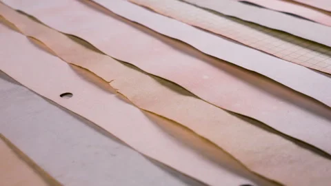 Handmade paper strips in soft earthy tones of terracotta, dusty rose. Stock Footage 330270710