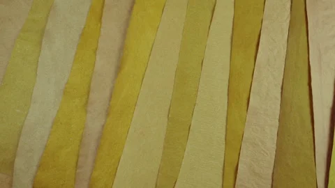 Handmade paper strips in warm yellow and beige tones. Stock Footage 330267564