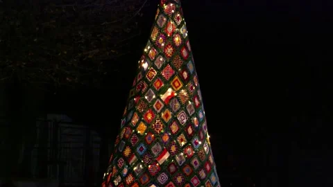 Handmade patchwork Christmas tree lit up at night Stock Footage 295213208