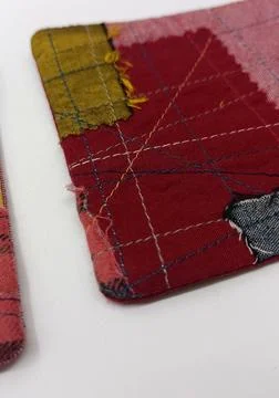 Handmade patchwork coaster from fabric remnants Stock Photos