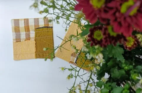 Handmade patchwork coasters with decorative flowers.  Stock Photos