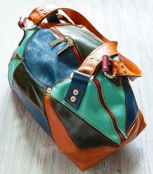 Handmade patchwork leather travel bag on gray 写真素材