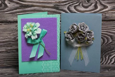 Handmade postcards. With decorative elements in the form of flowers and ribbo Stock Photos