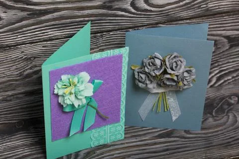 Handmade postcards. With decorative elements in the form of flowers and ribbo Stock Photos