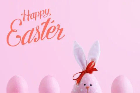 Handmade rabbit among Easter eggs, concept of celebration and fun. Text, happ 库存照片