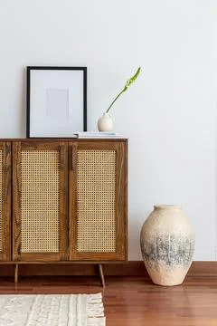 Handmade rattan chest of drawers with papier mache vase Stock Photos
