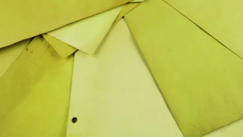 Handmade recycled paper sheets in olive and pale yellow tones rotating. Stock Footage 330255654