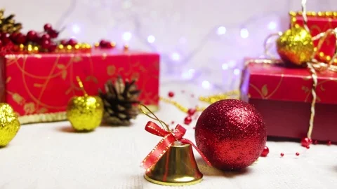 Handmade red gift boxes and New Year's decorations, golden apples, a bumps and a Video stock 82406586