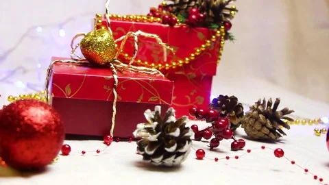 Handmade red gift boxes and Christmas decorations with shimmering lanterns Video stock 82407642