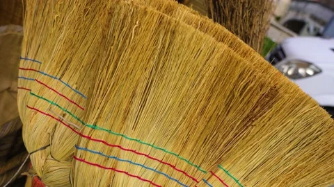 Handmade reed brooms with colored strips in marketplace Stock Footage 151481810