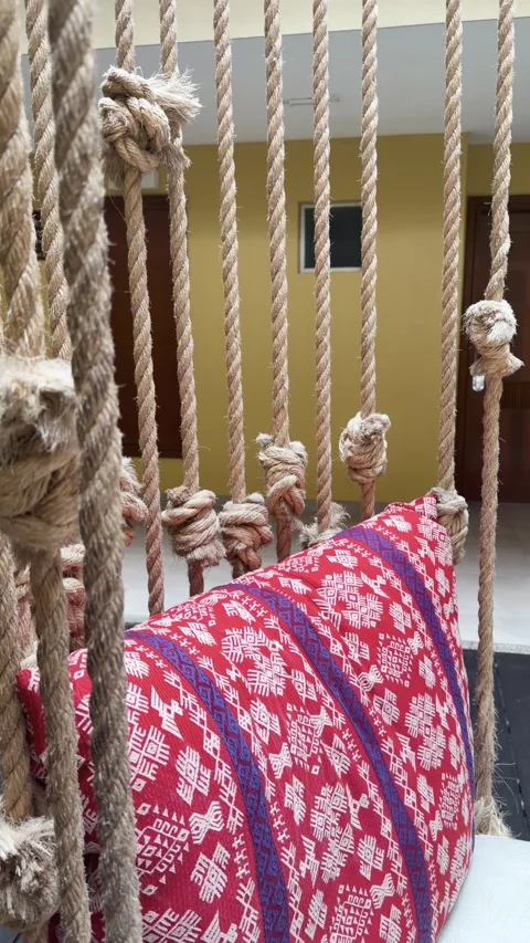 Handmade Rope Macrame Divider and Patterned Cushion in Cozy Indoor Home Interior Stock Footage 342351689