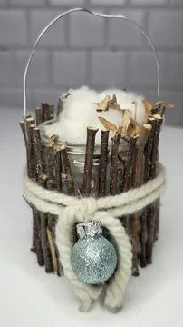 Handmade rustic candle holder made of twigs and white yarn with blue shiny .. Stock Photos