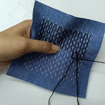 Handmade sashiko stitching in progress on fabric Stock Photos