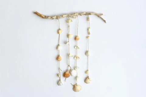 Handmade seashell mobile. Seashells hanging in the middle of a white backgrou Stock Photos