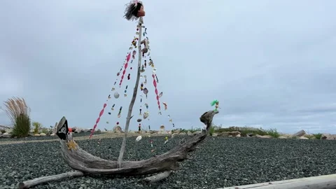 Handmade ship made from dry branches Seashell beads and a pirate flag Against Stock Footage 204862239