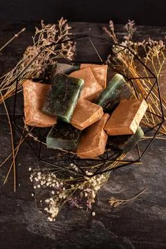 Handmade Soap Bars Nestled in a Wire Basket, Surrounded by Delicate Dried F.. Stock Photos