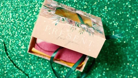 Handmade soap in festive packaging on a shiny green background. Stock Footage 169078506
