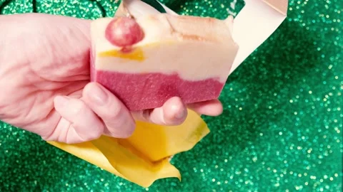 Handmade soap in festive packaging on a shiny green background. Stock Footage 169078560