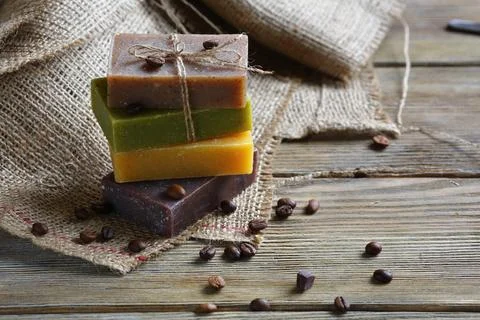 Handmade soap with roasted coffee beans, toiletries on sacking Stock Photos