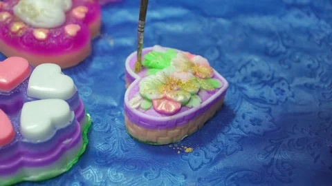 Handmade soap in the shape of heart is being covered with the sparkles Stock Footage 74361909