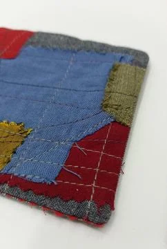 Handmade textile coaster with patchwork design Stock Photos