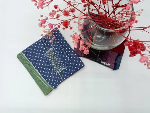 Handmade textile pieces including patchwork fabric squares. Stockfoto's