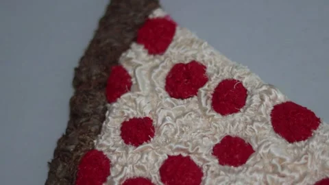 A handmade textile pizza slice featuring textured white fabric cheese. Stock Footage 337504775