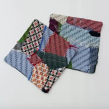 Handmade textile squares with mixed patterns. 库存照片