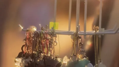 Handmade trinkets keychains pendants are on display at market stall. Local Stock Footage 315509798