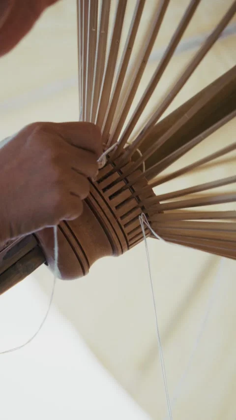 Handmade umbrella making close up tying bamboo structure in factory workshop Video stock 328483882