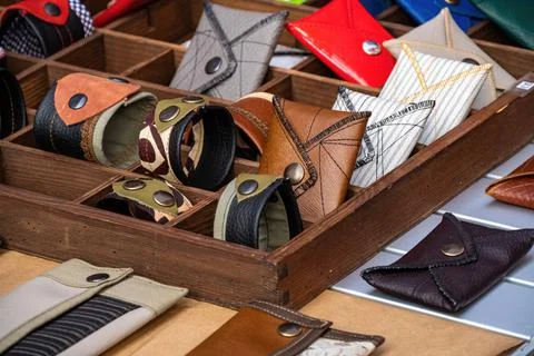 Handmade wallets and bracelets, made of leather and fabric, with metal rivets Stock Photos