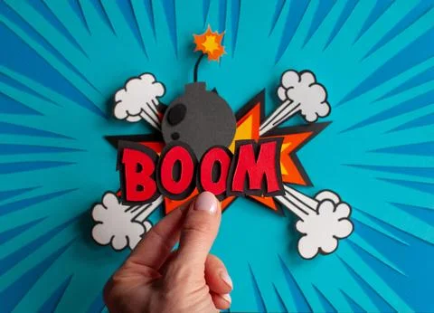 Handmade word boom in hand on comic background. Pop art and comic style. Stock Photos