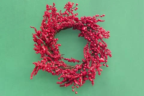 Handmade wreath made of twisted branches and glossy red berries Stock Photos