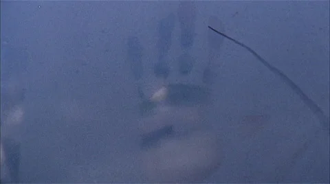 Handprint on blurry window Stock Footage 47013474