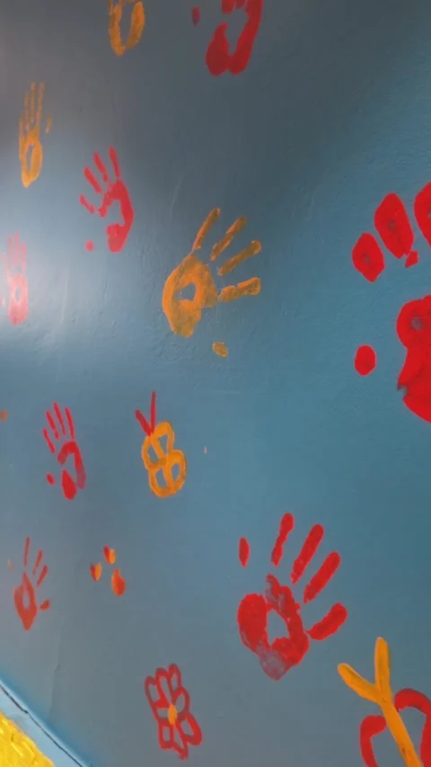 Handprints on a blue wall in a creative space with bright colors Stock Footage 347180111