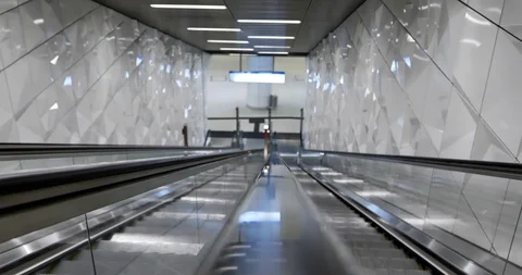 Handrail of moving down escalator and background of shiny tunnel stairway. Stock Footage 114836828