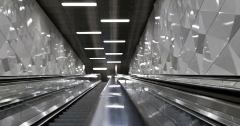 Handrail of moving up escalator and background of modern shiny tunnel stairway. Stock Footage 114836772
