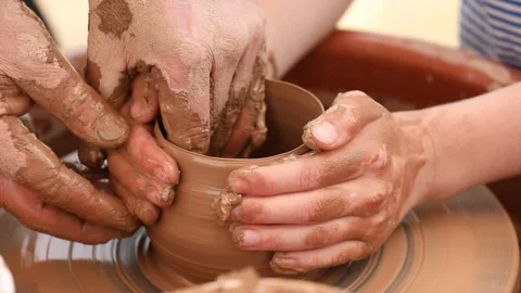 Hands of 2 people working with clay in the frame 스톡 동영상 333508373
