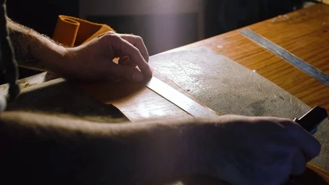 The hands of 20s 30s craftsman is measuring ruler master skin in his workshop Stock Footage 71389232