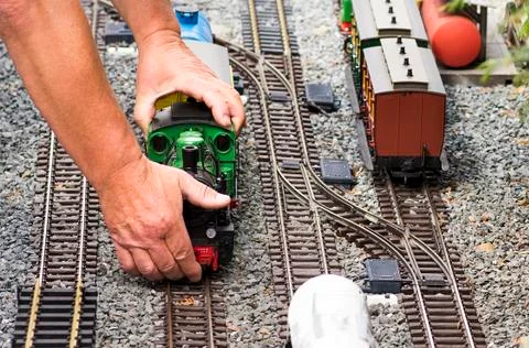 Hands about to pick up Train model set Stock Photos