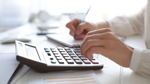 	 The hands of an accountant work on a calculator and prepare a financial report Video stock 110792047