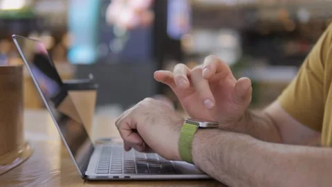 Hands actively using laptop in bright indoor setting Stockbeeldmateriaal 342587436