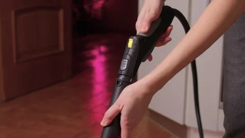 Hands actively using a vacuum cleaner in a clean and modern kitchen environment Stock Footage 305872784