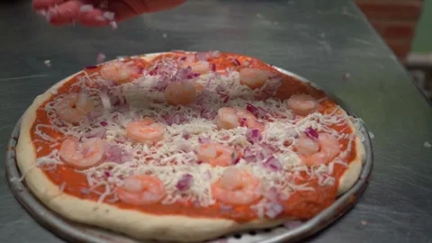Hands Adding Chopped Onion to a Pizza Stock Footage 293252212