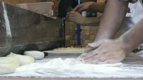 Hands adding ingredients on pizza dought and hands preparing dought Video stock 12274338