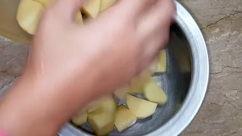 Hands Adding Potato Chunks to Pot for Boiling, Kitchen Stock Footage, Meal  Stock Footage 329094757