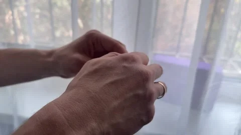 Hands adjust the back strap of a cap, pulling and tightening to fit the head Video stock 335073777