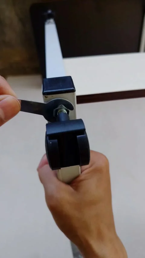 Hands adjust a clamp's setting with precision and care Stock Footage 331846324