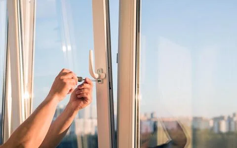 Hands adjust the plastic window Stock Photos